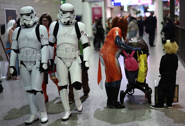 Cosplayers attend the MCM Comic Con at ExCeL exhibition centre in London on October 27, 2023. (Photo by HENRY NICHOLLS / AFP)