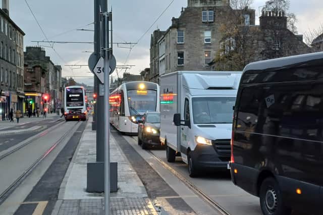 A tram stuck behind traffic on Leith Walk