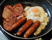 Egg, sausages and bacon being fried in a frying pan