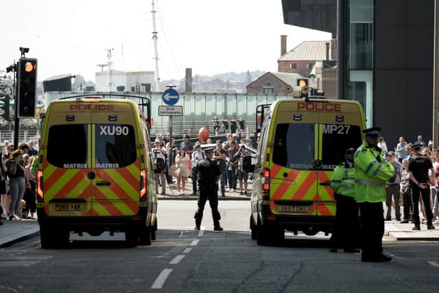 Police officers and vehicles stand guard outside Liverpool Magistrates' Court where Axel Rudakubana, 17, is appearing charged with the murders of three girls and the attempted murder of 10 others. Picture: Christopher Furlong/Getty Images