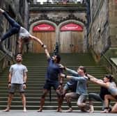 Acrobats from the troupe Gravity & Other Myths perform their new show 'Ten Thousand Hours' outside Assembly Hall. 