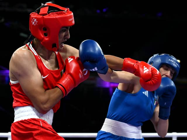 Algeria's Imane Khelif, in red, punches Italy's Angela Carini in the women's 66kg boxing event at the Paris Olympics on Thursday (Picture: Mohd Rasfan/AFP via Getty Images)