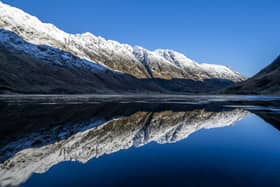 The snow covered peaks in Glencoe reflected in Loch Achtriochtan