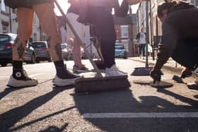 Local people in Middlesbrough clean up their streets after far-right rioters attacked police, smashed windows and set a car on fire (Picture: Ian Forsyth/Getty Images)
