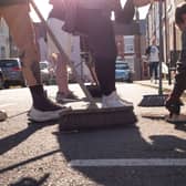 Local people in Middlesbrough clean up their streets after far-right rioters attacked police, smashed windows and set a car on fire (Picture: Ian Forsyth/Getty Images)