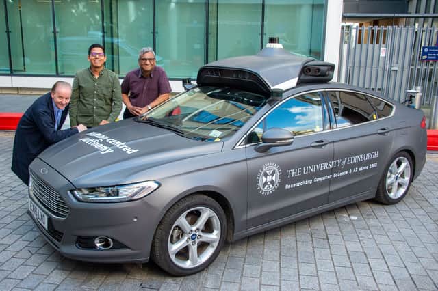 Professor Subramanian Ramamoorthy, right, with colleagues Jim Duffin, left, and Hector Cruz beside their car which is collecting data from Edinburgh's streets using cameras and sensors