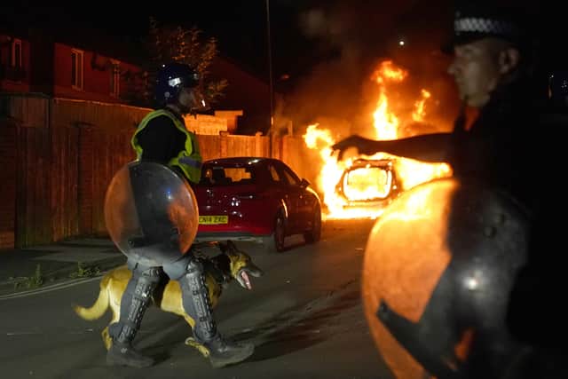 A police car burns as officers are deployed on the streets of Hartlepool following a violent protest. Picture: PA