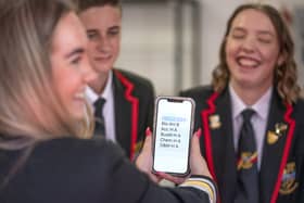 Students at Lochgelly High School in Lochgelly, Fife, check their results on a smart phone