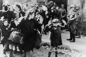 Jewish civilians are held at gunpoint by German SS troops after being forced out of a bunker where they were sheltering during the Warsaw Ghetto Uprising in 1943 (Picture: Keystone/Hulton Archive/Getty Images)