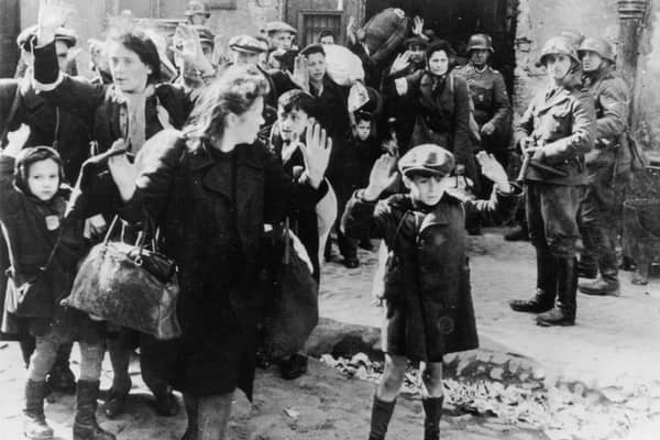 Jewish civilians are held at gunpoint by German SS troops after being forced out of a bunker where they were sheltering during the Warsaw Ghetto Uprising in 1943 (Picture: Keystone/Hulton Archive/Getty Images)