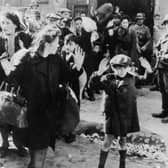 Jewish civilians are held at gunpoint by German SS troops after being forced out of a bunker where they were sheltering during the Warsaw Ghetto Uprising in 1943 (Picture: Keystone/Hulton Archive/Getty Images)