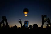 The Olympic Cauldron as it takes off at the sunset