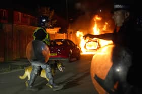 A police car burns as officers in riot gear restore order to the streets of Hartlepool (Picture: Owen Humphreys/PA)