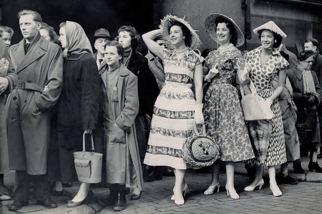 Models from a Dundee department store photographed in the bus queue outside by Alex Coupar in 1957.