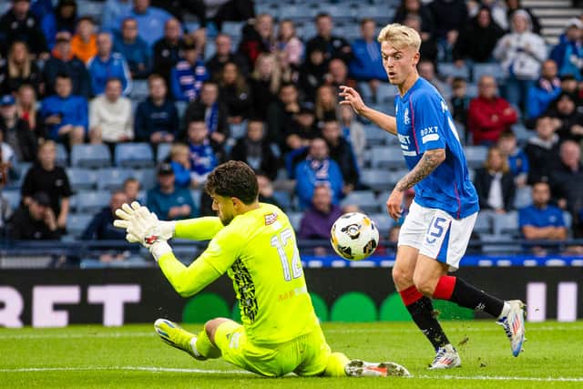 Ross McCausland chips home Rangers' second goal.