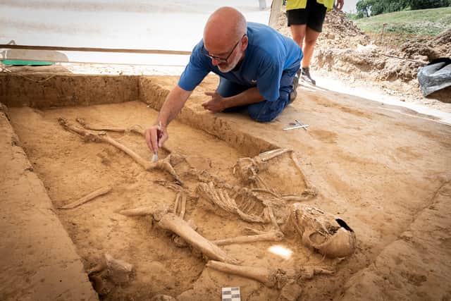 Belgian archaeologist Dominique Bosquet working on a human skeleton found in 2022 at the site of the Battle of Waterloo in Belgium. Picture: Chris van Houts/Waterloo Uncovered/PA Wire