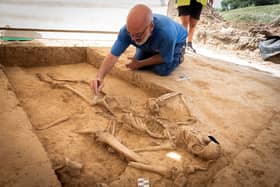 Belgian archaeologist Dominique Bosquet working on a human skeleton found in 2022 at the site of the Battle of Waterloo in Belgium. Picture: Chris van Houts/Waterloo Uncovered/PA Wire