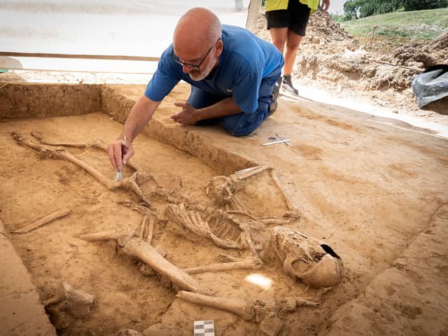 Belgian archaeologist Dominique Bosquet working on a human skeleton found in 2022 at the site of the Battle of Waterloo in Belgium. Picture: Chris van Houts/Waterloo Uncovered/PA Wire
