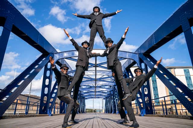Acrobats from The Black Blues Brothers show off some of their tricks and athletic prowess on Leith's Victoria Swing Bridge. The UK-wide Campaign for the Arts have launched a new petition in a bid to get the Scottish Government to deliver its £100m guarantee in funding. Picture: Jane Barlow/PA Wire