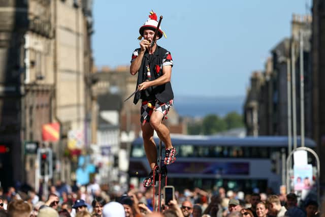 A juggling performer eats a potato on Edinburgh's Royal Mile during the Fringe. Picture: Jeff J Mitchell/Getty Images