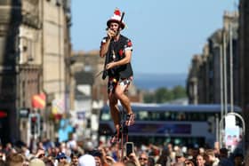 A juggling performer eats a potato on Edinburgh's Royal Mile during the city's Festival Fringe. Picture: Jeff J Mitchell/Getty Images