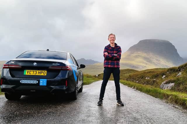 Alastair Dalton taking a break from driving an electric BMW i5 on the lower slopes of the mountain pass to Applecross on the North Coast 500 on Thursday