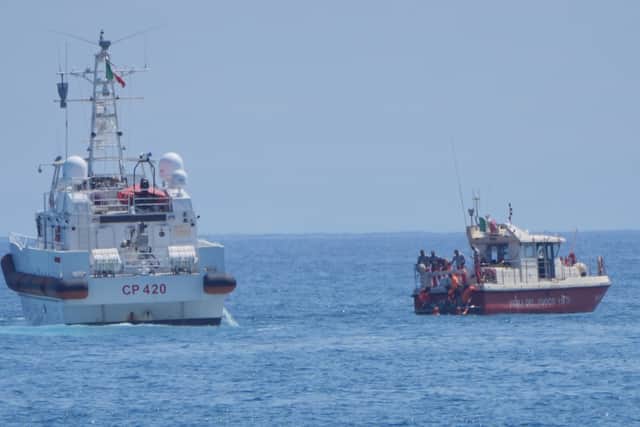 Members of the rescue team place a body bag onto the lower half of the deck of the fire service dive team boat on the fifth day of the search and recovery operation, after the luxury yacht Bayesian sank in a storm on Monday whilst moored around half a mile off the coast of Porticello, Sicily.