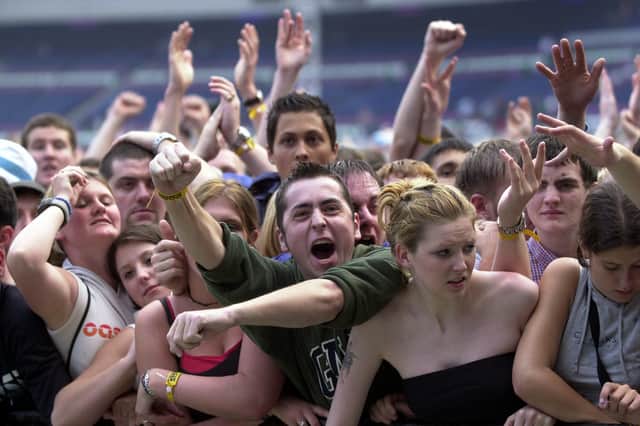 Fans in the front row for the last Oasis concert at Murrayfield Stadium in 2009.