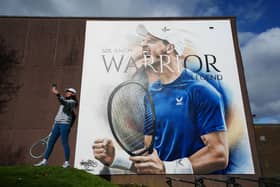Club member Indriana Arifin takes a selfie with the 20ft artwork outside Dunblane Sports Club of Sir Andy Murray depicting the three-time grand slam winner cheering and celebrating a victory. Picture: Andrew Milligan/PA Wire