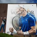 Club member Indriana Arifin takes a selfie with the 20ft artwork outside Dunblane Sports Club of Sir Andy Murray depicting the three-time grand slam winner cheering and celebrating a victory. Picture: Andrew Milligan/PA Wire