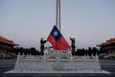 Guards raise Taiwan's national flag on Democracy Boulevard in Taipei (Picture: Yasuyoshi Chiba/AFP via Getty Images)