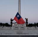 Guards raise Taiwan's national flag on Democracy Boulevard in Taipei (Picture: Yasuyoshi Chiba/AFP via Getty Images)