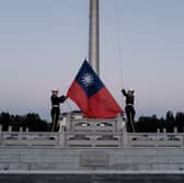 Guards raise Taiwan's national flag on Democracy Boulevard in Taipei (Picture: Yasuyoshi Chiba/AFP via Getty Images)