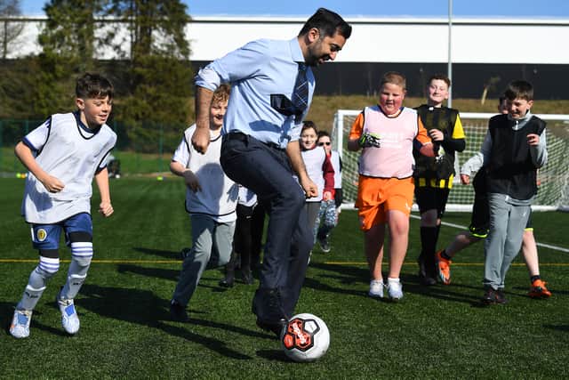 Former First Minister Humza Yousaf plays football with children in Ayr (Picture: Andy Buchanan/pool)