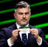 Hearts are pulled out of the hat by former Poland international Michal Zewlakow during the Conference League draw at the Grimaldi Forum in Monaco. (Photo by VALERY HACHE/AFP via Getty Images)