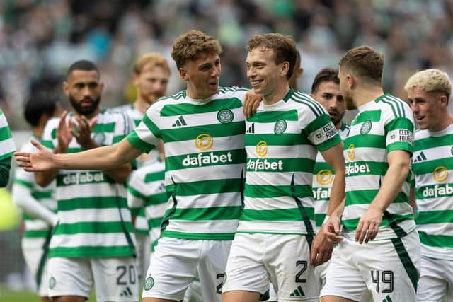The Celtic players celebrate their triumph in the Old Firm derby.