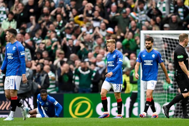 The Rangers players look on disconsolately during the defeat at Parkhead.