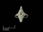 The Pictish ring, complete with red garnet or red glass stone, found at Burghead in Moray.