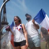Spectators cool off under water misters in front of the Eiffel Tower on day four of the Paris Olympic Games  (Picture: Maja Hitij)
