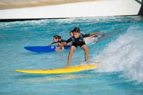 Young surfers enjoying the waves at an existing Wavegarden facility