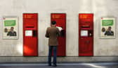 A man puts a letter get into a postbox at a Post Office. Picture: Adrian Dennis/AFP via Getty Images