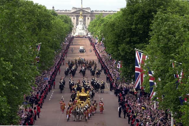 The Golden Coach carrying Queen Elizabeth II during the Golden Jubilee celebrations in The Mall in 2002, viewed from Admiralty Arch looking towards Queen Victoria Memorial and Buckingham Palace, London. A new national memorial a new national memorial in honour of Queen Elizabeth II will stand in St James's Park in the heart of London.