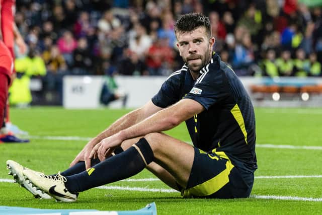 Scotland's Grant Hanley looks dejected after giving away a penalty in injury time that allowed Poland to claim a 3-2 win at Hampden. (Photo by Craig Foy / SNS Group)