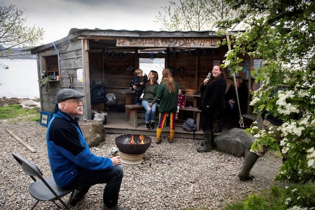 Locals sit and drink at 'The Table', a wooden shed near The Old Forge pub, in Inverie on the Knoydart peninsula.