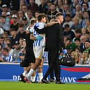 Matt O'Riley is helped from the pitch after getting injured less than 10 minutes into his Brighton debut. (Photo by Mike Hewitt/Getty Images)
