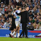 Matt O'Riley is helped from the pitch after getting injured less than 10 minutes into his Brighton debut. (Photo by Mike Hewitt/Getty Images)