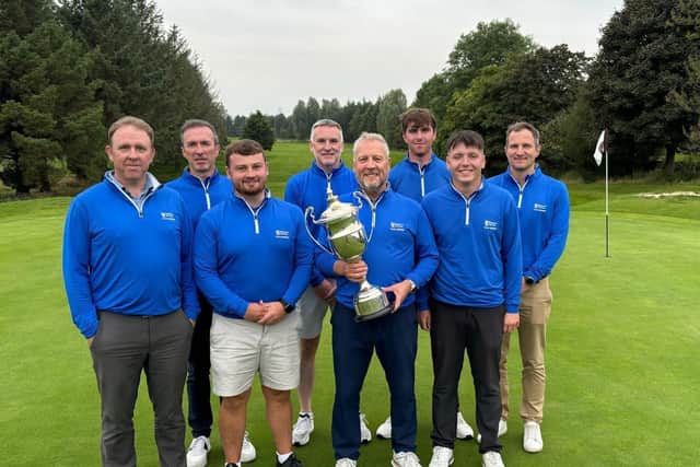 Glenbervie team manager Tommy Wilson and his players show off the Stirlingshire Inter-Club Trophy