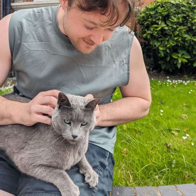 Alexander Brown and a cat that is not Larry, and therefore nice to him