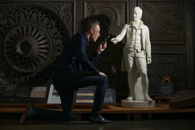 Historic Environment Scotland collections registrar Ross Irving with the statue of Robert Burns