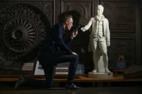 Historic Environment Scotland collections registrar Ross Irving with the statue of Robert Burns